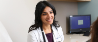 Dr. Helai Hesham smiling and speaking with a patient